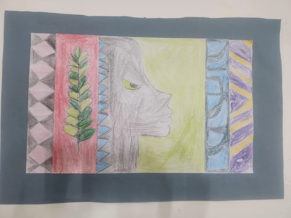 Coloured-pencil artwork of a face in profile between patterned borders, mounted on grey paper